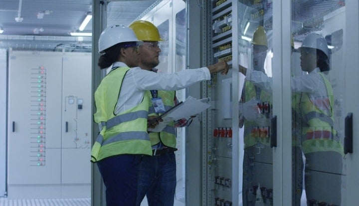two-electrical-workers-walking-in-the-control-room-picture-id1061016506