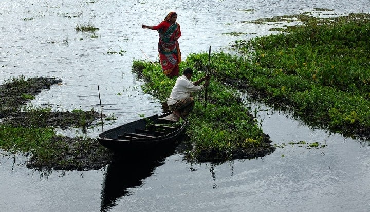 A family tends to their floating farms in Bangladesh