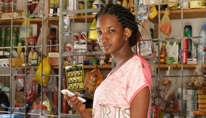 Woman in shop holding mobile phone