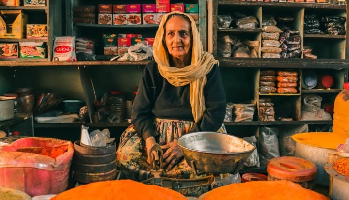 Female shop owner surrounded by produce in Pakistan