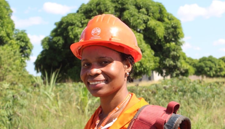 Training Diversity and Inclusion in the Workplace: a young black woman dressed for work wearing an orange hard hat