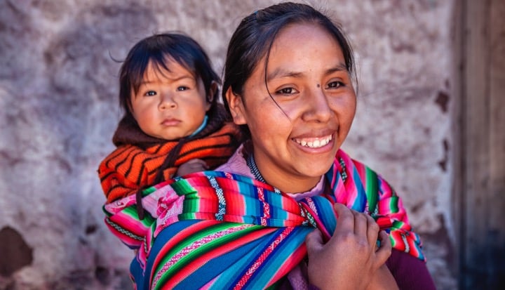 Peruvian woman with her baby on the back -
