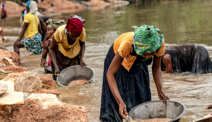 Women workers panning for precious metals.