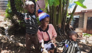 woman with two sons in rural setting